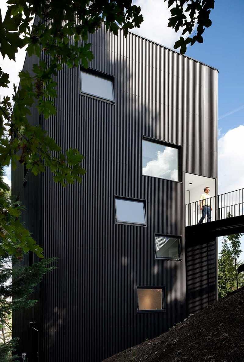 Modern Vertical House Accessed by a Steel Pedestrian Bridge