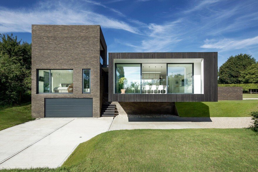 Black Modern House Consisting of Five Modules Clustered Around a Central Courtyard 5
