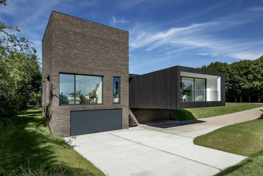Black Modern House Consisting of Five Modules Clustered Around a Central Courtyard 13