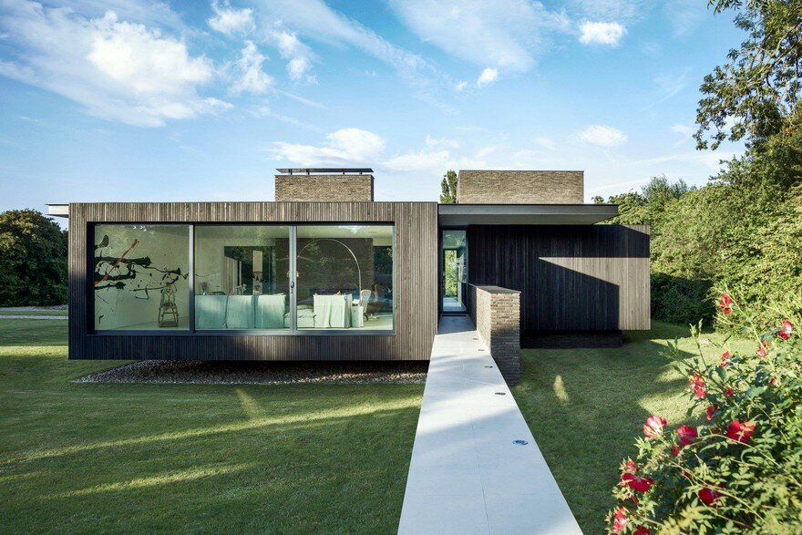 Black Modern House Consisting of Five Modules Clustered Around a Central Courtyard 4