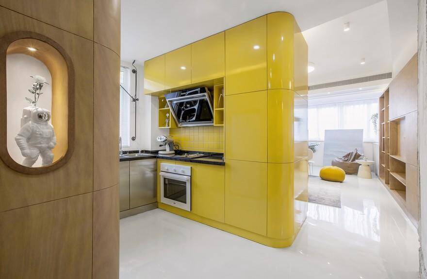 Economical Residence in Shanghai , the yellow kitchen box together with the cabinets becomes the center of the space