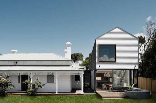 an old house extended with two contemporary sculptural pavilions