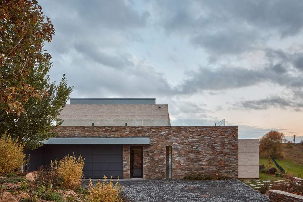 A Stone-Clad Villa Built into a Slope in Bohemian Paradise