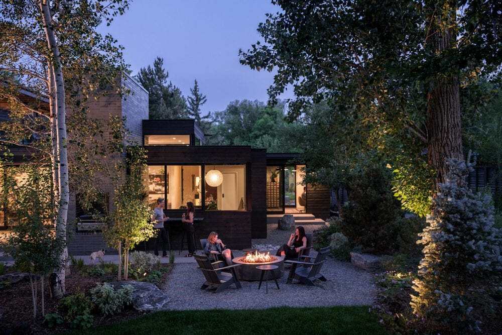 The backyard features low-water plantings and a cozy fire pit