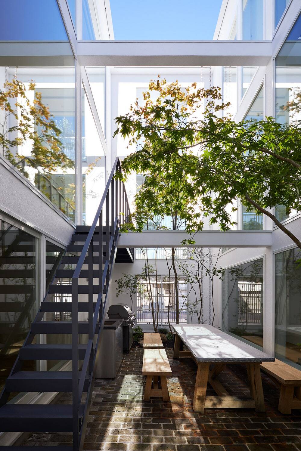 House Connected by Courtyard by Naf Architect & Design